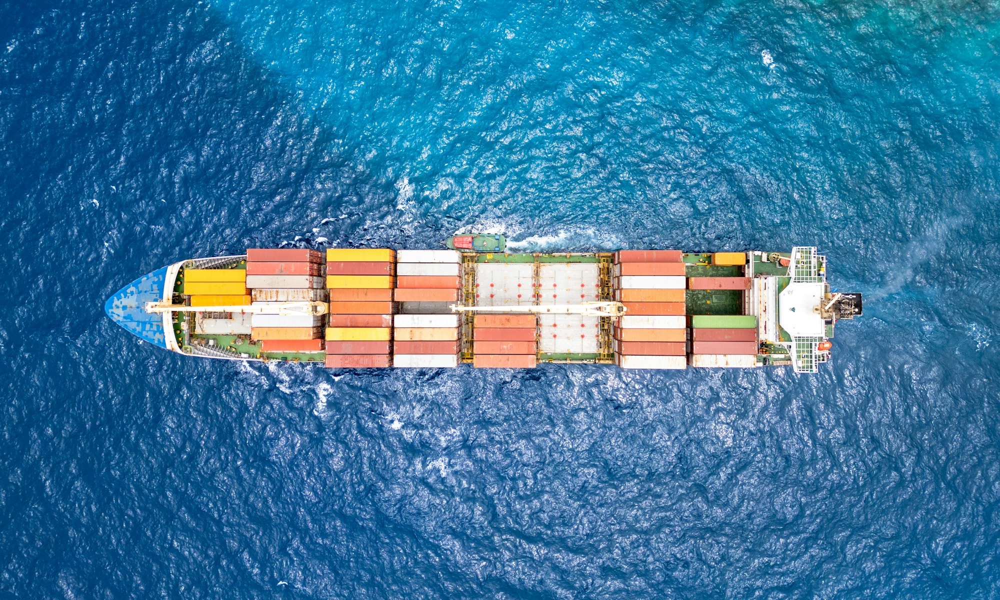 A container ship at sea, photographed from above.